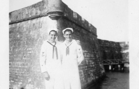 two sailors in front of the fort