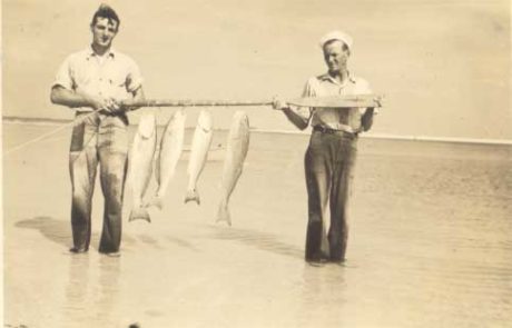 men holding fish they have caught